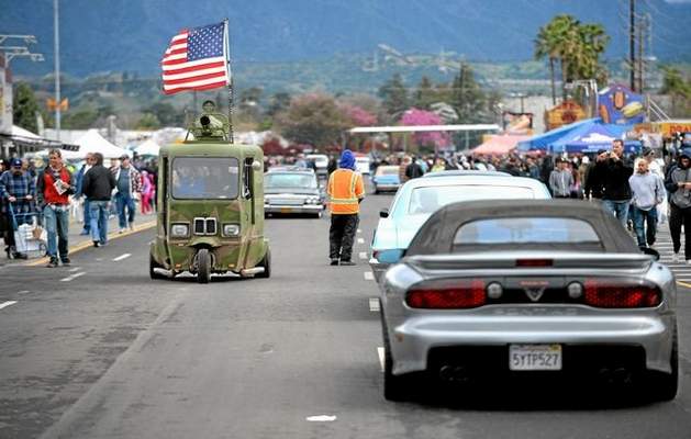Customikes at Pomona Swap Meet 2015 Mikael Wallin, left, drives a 1962 Cushman Westcoaster down the main road during the Pomona Swap Meet and Classic Car Show on Sunday at Fairplex in Pomona. photos by micah escamilla — staff photographer
